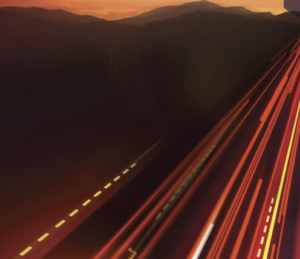 Blurred car headlights with background mountain view