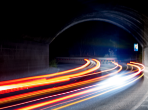 car lights in bending road with bridge