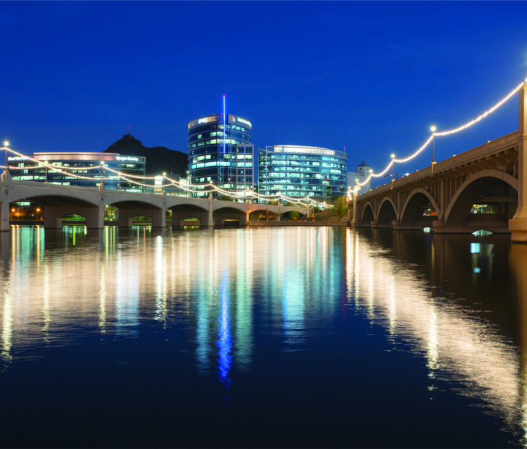 Water view of bridge and city buildings in background